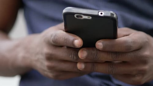 Close Up of Man Using Smartphone