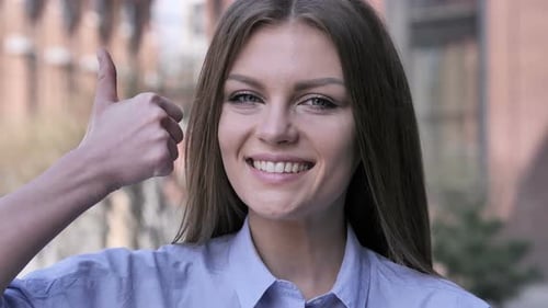 Happy Woman Gives Thumbs Up Close Up