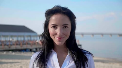 Woman Smiling and Posing on Sunny Beach