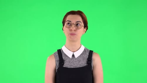 Portrait of Funny Girl in Round Glasses Is Waiting with Boredom, Green Screen