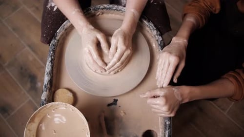 Man Potter Working on Potters Wheel Making Ceramic Pot From Clay in Pottery Workshop