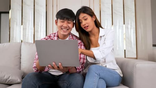 Couple Using Laptop Together at Home