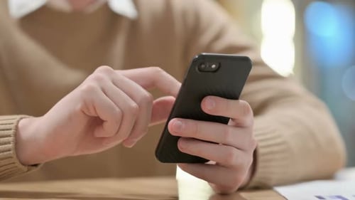 Hand Close Up of Young Man Using Smartphone