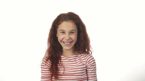 Smiling Young Girl Putting on Captain's Hat