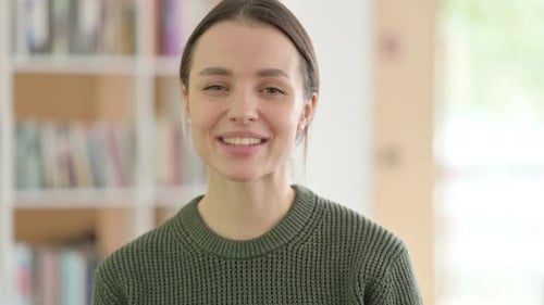 Smiling Woman Waving and Talking to Camera