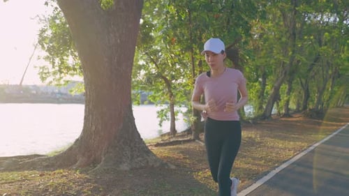 Asian young beautiful sport woman exercise by running workout on street in public park.