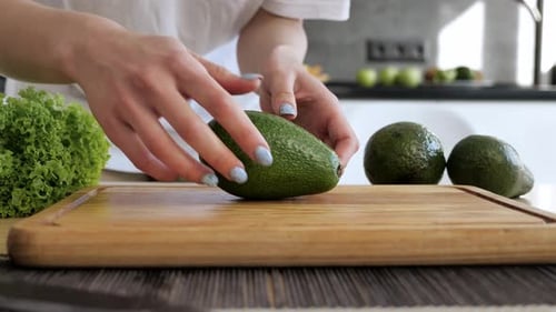Preparing Fresh Avocado in Modern Kitchen
