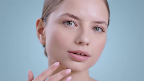 Woman Touches Her Face in Close Up