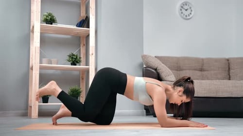 Woman Doing Donkey Kicks in Her Home