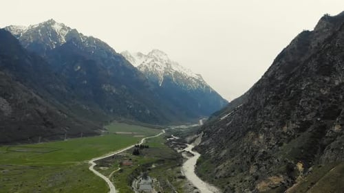 Aerial View of Valley Through Which Mountain River Flows