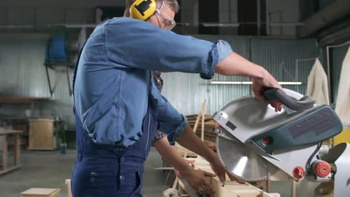 Men Cutting Lumber in Woodworking Shop