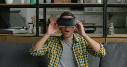 Young Man Experiences VR Immersion at Home