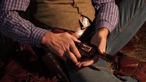 Man Loads Revolver in Wild West Clothing