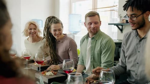 Friends Enjoying Wine and Meal Together Indoors
