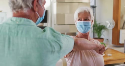 Elderly Couple Greeting Each Other with Elbow Bump