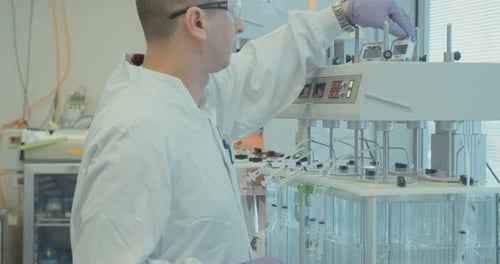 Man Operating Lab Equipment in a Hospital Lab