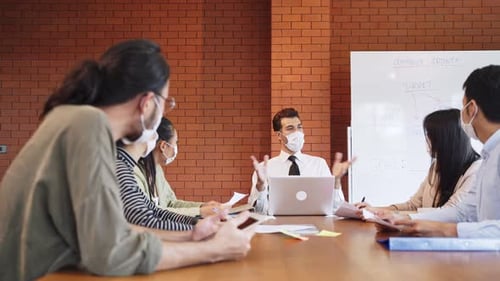 Group of Asian young business people wear face mask and working on computer in office workplace.