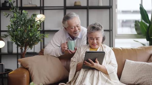 Elderly Couple Using Tablet Together at Home