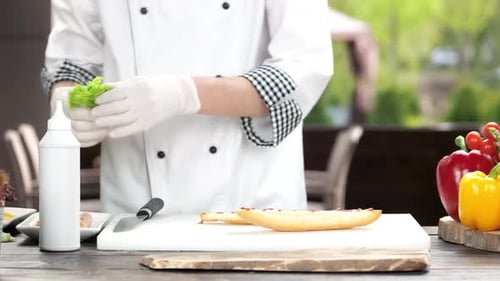 Chef Preparing Fresh Sandwich With Lettuce Outdoors