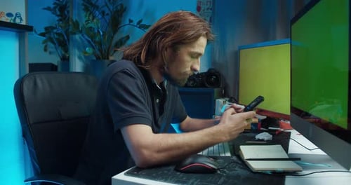 Adult Man Using Computer and Blowing Nose