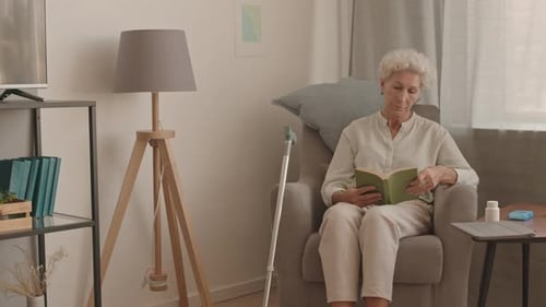 Senior Lady Reading in Armchair