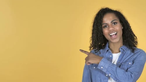 Woman Points and Smiles to the Side