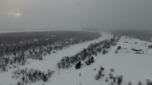 Flying Over Small Village In Winter