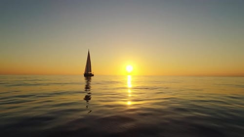 Spain Sunset over the Horizon While Sailboat is Floating
