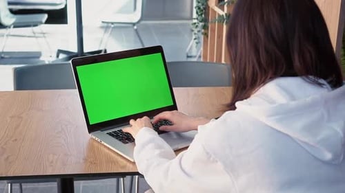 Shot Over Shoulder Caucasian Business Woman Working in an Office Interior at Computer on Desk
