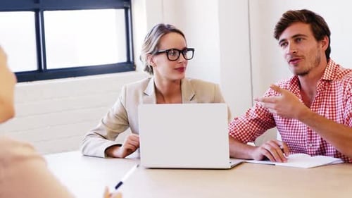 Collaborative Office Meeting at Conference Table