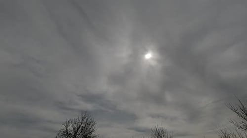 Sun Shining Through Grey Clouds in the Sky