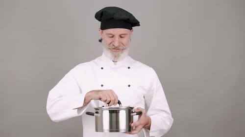 Chef Holding Pot Opens the Lid