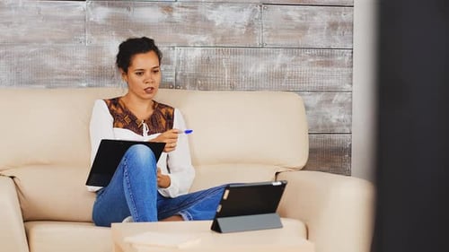 Woman on Couch Conducting Online Meeting