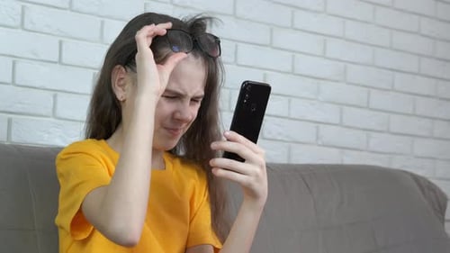 Girl Using Phone Gets Tired Eyes