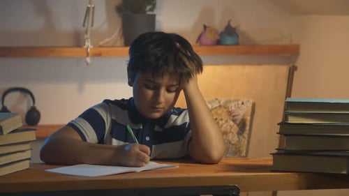 Boy Struggling with Homework at Desk