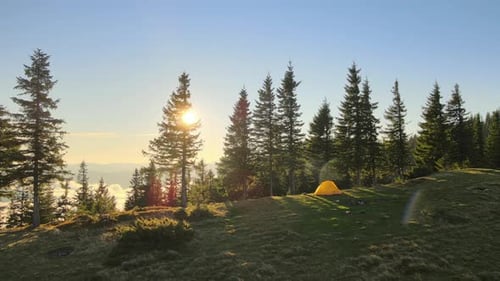 Aerial View of Tourist Camping Tent on Mountain Campsite at Bright Sunny Evening