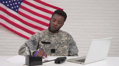 American Soldier Working on Laptop in Headquarters Building
