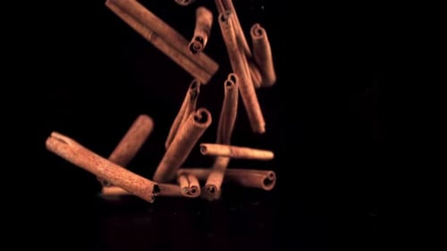 Super Slow Motion Cinnamon Sticks Fall on the Table in a Heap