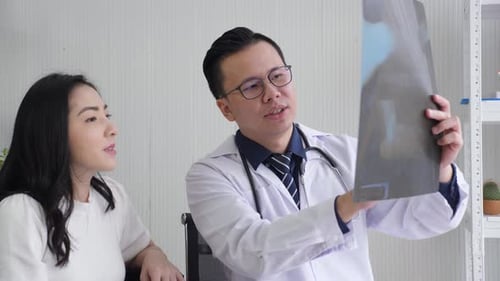 Doctor Explains X-Ray to Patient in Bright Office