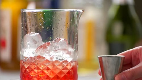 Cocktail Being Poured into Glass with Ice