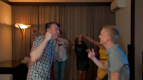 Two Guys and Their Friends Dancing at Home Party
