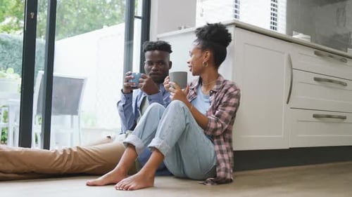 Relaxed Couple Enjoying Coffee in Kitchen
