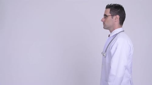 Profile View of Handsome Man Doctor Wearing Eyeglasses Against White Background