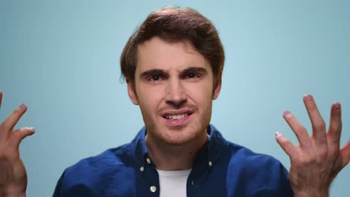 Displeased Man Gesturing with Hands at Camera. Annoyed Guy Posing in Studio