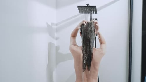 Woman Washing Long Brunette Hair in Shower