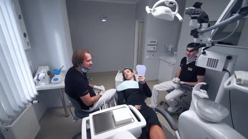 Woman having visit at dentist. Female patient talking to dentist in dental clinic