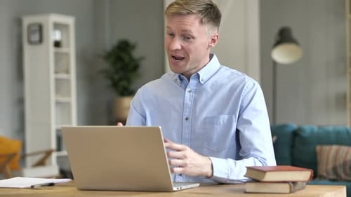 Businessman Talking During Online Video Chat at Work