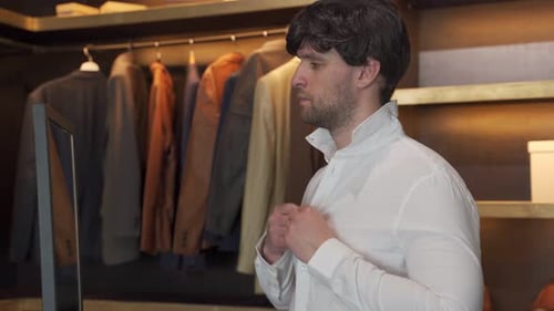 Young Man Buttons Shirt in Modern Wardrobe