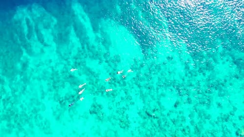Daytime aerial island view of a white paradise beach and blue sea background in best quality 4K