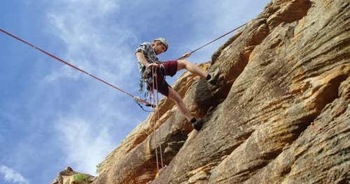 Mounatineer rappelling down from the mounatin
